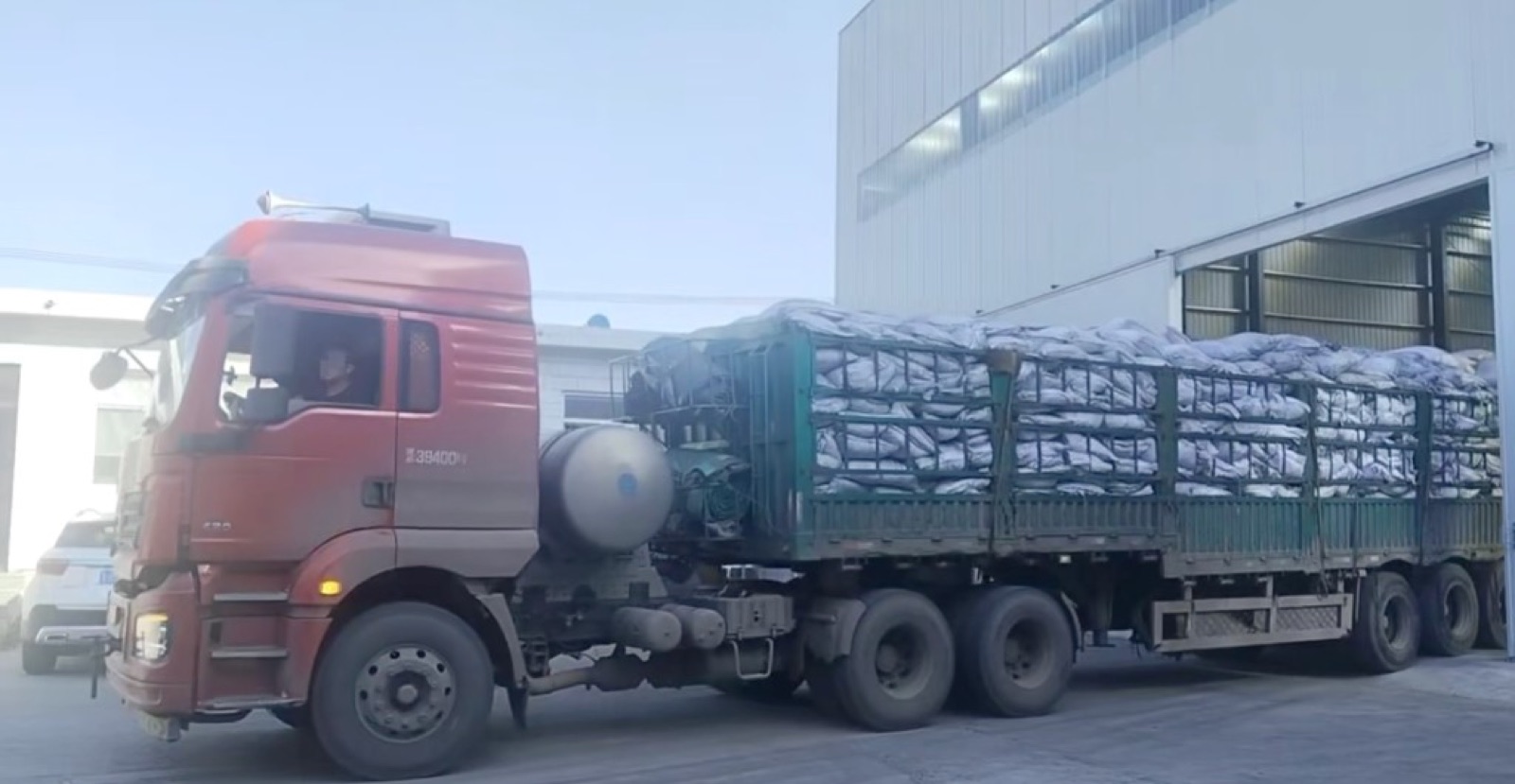 Truck transferring bagged coconut shell charcoal at an activated carbon factory in China